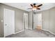 Bedroom featuring three doors, a ceiling fan and carpet floors for comfortable living at 753 Southwest Dr, Davidson, NC 28036