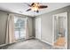 Neutral bedroom featuring a ceiling fan, plush carpet, and an ensuite bathroom at 753 Southwest Dr, Davidson, NC 28036