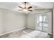 Bright bedroom featuring a ceiling fan and sliding glass doors to a private balcony at 753 Southwest Dr, Davidson, NC 28036