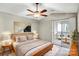 Cozy bedroom featuring soft carpet, a ceiling fan, and sliding glass doors to the screened in porch at 753 Southwest Dr, Davidson, NC 28036