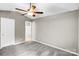 Bedroom with carpet flooring, a ceiling fan and an open doorway to a bathroom at 753 Southwest Dr, Davidson, NC 28036