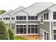 Rear exterior view of multi-story townhomes with screened-in porches and neutral siding at 753 Southwest Dr, Davidson, NC 28036