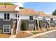 Charming exterior view of the townhouse with stairs leading to the front door and manicured landscaping at 753 Southwest Dr, Davidson, NC 28036