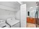 Convenient laundry area near kitchen equipped with a washer and dryer and useful wire shelving at 753 Southwest Dr, Davidson, NC 28036