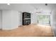 The open-concept living room features a fireplace with shelving, light wood floors, and access to outdoor living at 753 Southwest Dr, Davidson, NC 28036