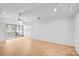The bright and spacious living room features light wood floors, ceiling fan, and sliding glass doors to the deck at 753 Southwest Dr, Davidson, NC 28036