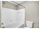 Bathroom featuring a white tiled shower with a shower head and faucet made of bronze at 753 Southwest Dr, Davidson, NC 28036