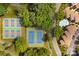 Aerial view of well-maintained tennis and pickleball courts in a lush, wooded community setting at 753 Southwest Dr, Davidson, NC 28036