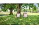 Tranquil backyard scene with comfortable outdoor seating beneath shady trees at 765 York Institute Rd, Hiddenite, NC 28636