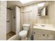 A basement bathroom featuring a walk-in shower, toilet, and vanity with sink at 765 York Institute Rd, Hiddenite, NC 28636