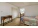 Bright bedroom featuring a desk, closet with folding doors and window at 765 York Institute Rd, Hiddenite, NC 28636
