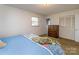 Relaxing bedroom featuring a wooden dresser, closet, and light-filled window at 765 York Institute Rd, Hiddenite, NC 28636