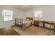 Bright bedroom featuring a wooden bed frame, desk, and well-lit windows at 765 York Institute Rd, Hiddenite, NC 28636