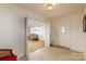Welcoming entryway with a view into the adjacent living area through open, bi-fold doors and a front door with decorative glass at 765 York Institute Rd, Hiddenite, NC 28636