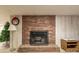 Basement fireplace features brick surround, hearth, and decorative accents at 765 York Institute Rd, Hiddenite, NC 28636
