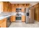 Charming kitchen with wood cabinets, stainless steel appliances, and laminate countertops for a cozy cooking space at 765 York Institute Rd, Hiddenite, NC 28636