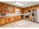 Traditional kitchen featuring wood cabinetry, stainless steel appliances, and durable tile flooring for a warm, inviting atmosphere at 765 York Institute Rd, Hiddenite, NC 28636