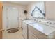 Bright laundry room features white appliances, a utility sink, and exterior access door at 765 York Institute Rd, Hiddenite, NC 28636