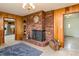 Inviting living room featuring a brick fireplace, wood paneling, and ample natural light at 765 York Institute Rd, Hiddenite, NC 28636