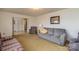 Inviting living room featuring neutral carpeting, classic furnishings, and an open doorway leading to other areas of the home at 765 York Institute Rd, Hiddenite, NC 28636