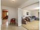 The living room offers a view to another room via bi-fold doors, neutral carpet, and comfortable furnishings at 765 York Institute Rd, Hiddenite, NC 28636