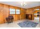 Comfortable living room with wood paneled walls, classic sewing machine and vintage chandelier at 765 York Institute Rd, Hiddenite, NC 28636