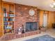 Cozy living room with a brick fireplace, built-in bookcase, and classic decor at 765 York Institute Rd, Hiddenite, NC 28636