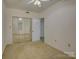 Bedroom with mirrored closet doors, beige carpet, and a ceiling fan at 8 Sunrise Point Rd, Lake Wylie, SC 29710