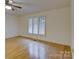 Bright bedroom with hardwood floors and large shuttered window at 8 Sunrise Point Rd, Lake Wylie, SC 29710
