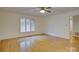 Bright bedroom with hardwood floors, plantation shutters, and a ceiling fan at 8 Sunrise Point Rd, Lake Wylie, SC 29710