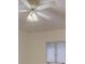 Ceiling fan with lighting fixture against a white ceiling in a room with a window at 8 Sunrise Point Rd, Lake Wylie, SC 29710