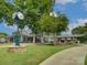 Exterior view of clubhouse with lush green grass and clocktower on beautiful summer day at 8 Sunrise Point Rd, Lake Wylie, SC 29710
