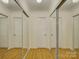 Hallway with mirrored closet doors and hardwood floors at 8 Sunrise Point Rd, Lake Wylie, SC 29710
