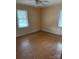Bright bedroom with hardwood floors and two windows offering natural light at 8000 Chapman St, Charlotte, NC 28216