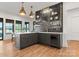 This wet bar area features custom cabinetry, a beverage fridge, and stylish lighting for entertaining at 8066 Edgewater Dr # 103, Norwood, NC 28128