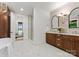 Bright bathroom features a double sink vanity, freestanding tub, and glass-enclosed shower at 8066 Edgewater Dr # 103, Norwood, NC 28128