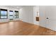 A bright primary bedroom features hardwood floors, natural light, and an ensuite bathroom at 8066 Edgewater Dr # 103, Norwood, NC 28128