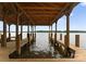 Covered boat slip featuring wooden beams and a scenic view of the lake at 8066 Edgewater Dr # 103, Norwood, NC 28128