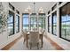 Bright dining room with floor-to-ceiling windows showcasing lake views, creating a serene atmosphere at 8066 Edgewater Dr # 103, Norwood, NC 28128