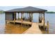 Covered dock featuring an expansive deck and boat slip at 8066 Edgewater Dr # 103, Norwood, NC 28128