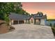 Charming two-story home featuring a large driveway, stone accents, and three-car garage at 8066 Edgewater Dr # 103, Norwood, NC 28128