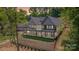 Rear exterior showcasing a multi-level deck with black railings, and large windows overlooking the property at 8066 Edgewater Dr # 103, Norwood, NC 28128