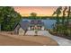Stunning lakefront home with a modern design and stone accents with breathtaking sunset views at 8066 Edgewater Dr # 103, Norwood, NC 28128