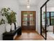 Inviting foyer featuring hardwood floors, double doors, and stylish decor, creating a warm and welcoming entrance at 8066 Edgewater Dr # 103, Norwood, NC 28128