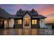 Charming home featuring a stone facade, dormer windows, and a welcoming front entrance, exuding curb appeal at 8066 Edgewater Dr # 103, Norwood, NC 28128