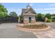 Community gate house with stone and shingle siding, featuring a decorative cupola and gated entrance at 8066 Edgewater Dr # 103, Norwood, NC 28128