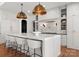 A spacious kitchen with a marble island and white cabinets, perfect for entertaining at 8066 Edgewater Dr # 103, Norwood, NC 28128