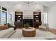 Bright living room features a fireplace flanked by dark wood built-in shelving, a coffee table, and neutral furnishings at 8066 Edgewater Dr # 103, Norwood, NC 28128