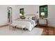 Comfortable main bedroom features a plush bed, side tables, and stylish decor at 8066 Edgewater Dr # 103, Norwood, NC 28128