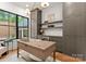 Stylish office with built-in shelving, a wooden desk, and a large window, perfect for a productive workspace at 8066 Edgewater Dr # 103, Norwood, NC 28128